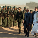 United Nations Secretary-General Kofi Annan (C) reviews troops along with Polisario Front chief Mohamed Abdelaziz (R) upon arriving to a Polisario refugee camp in Smara, Western Sahara, November 30. Annan said after talks with Polisario Front leaders that he had won a "clear yes" from them on his peace plan to resolve the long-running Western Sahara dispute. ES/CLH/ - RP1DRIFRGXAF